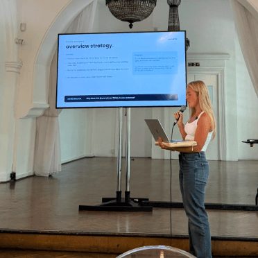 A teammate presenting an overview-strategy session from a stage