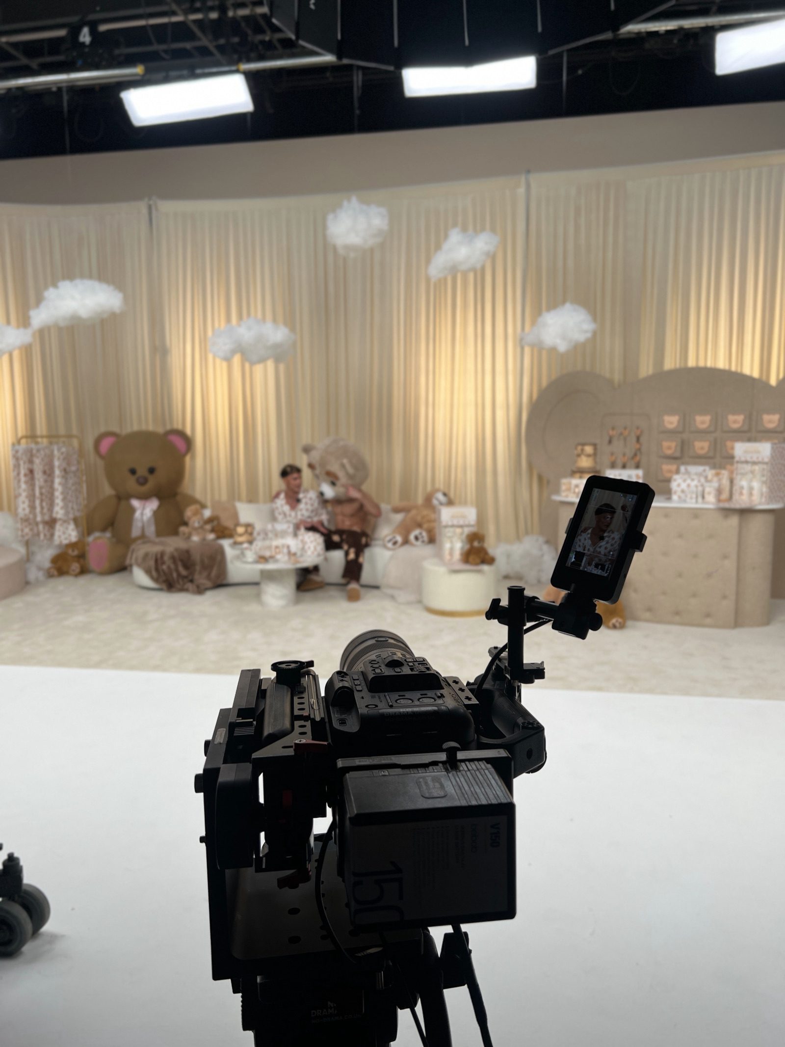 Crew members working on a teddy-bear themed LIVE set
