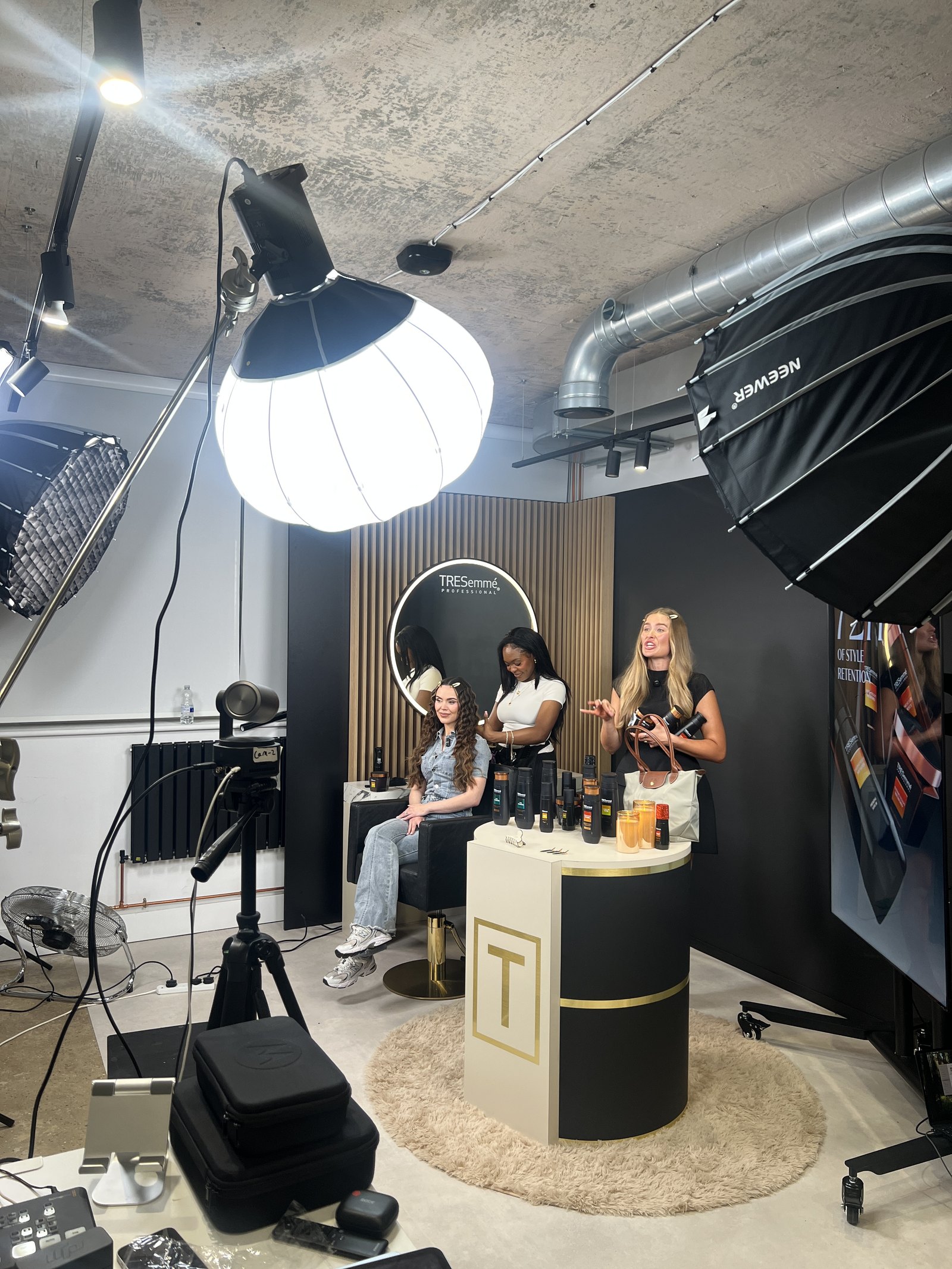 Hosts and stylist on a TRESemmé Professional LIVE set between takes