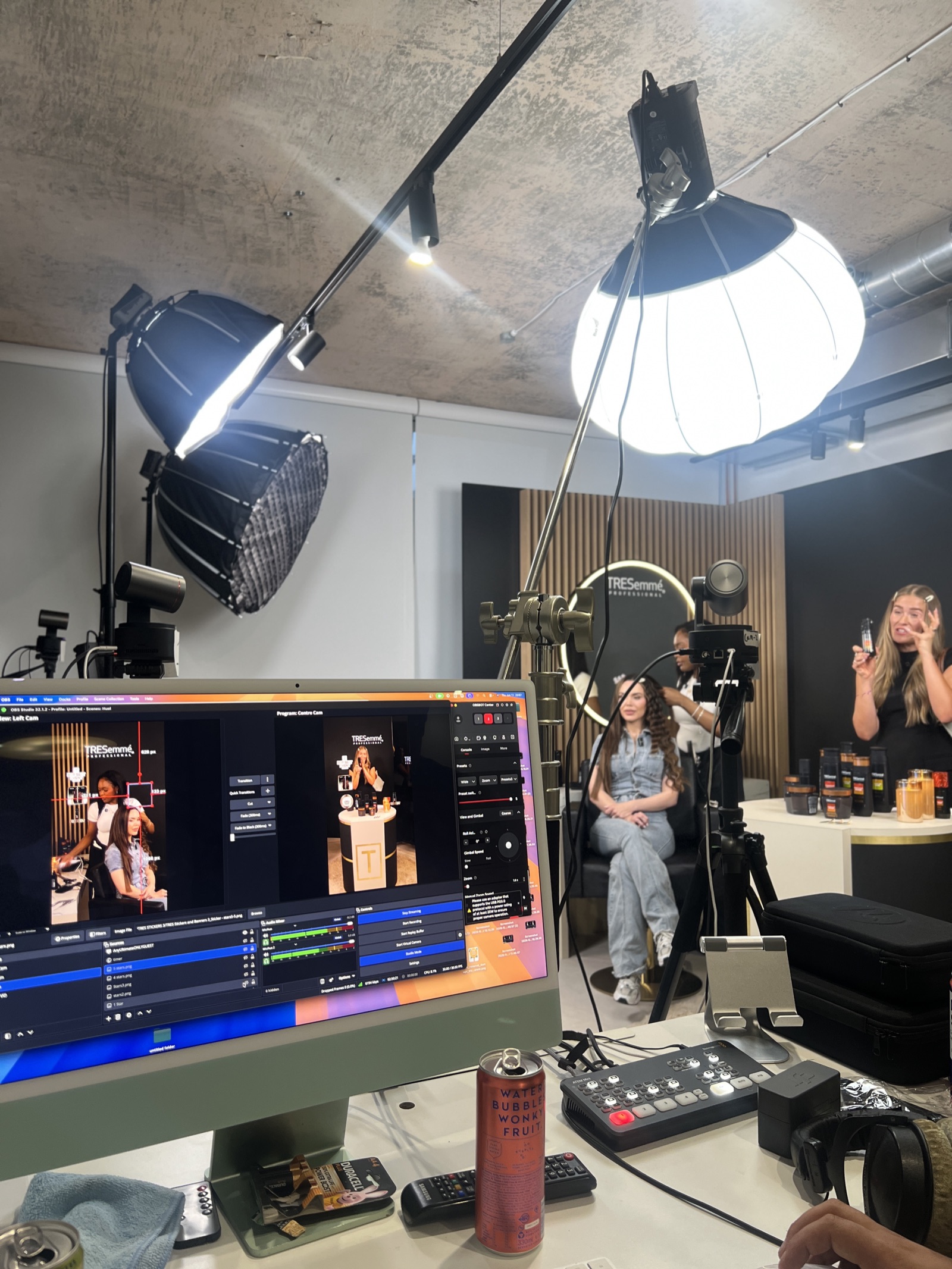 The TRESemmé LIVE production monitor showing multi-camera views, with the set and stylist working behind it